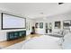 Large bedroom with a movie screen, hardwood floors, and a comfortable chaise lounge at 501 Brightwaters Ne Blvd, St Petersburg, FL 33704