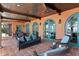 Relaxing covered patio with terracotta tile, comfortable seating, and views of the surrounding water at 501 Brightwaters Ne Blvd, St Petersburg, FL 33704