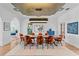 Open dining room features a modern light fixture, wood floors and seating for eight at 501 Brightwaters Ne Blvd, St Petersburg, FL 33704