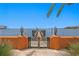 Waterfront home featuring private wooden dock with gate, stunning ocean views, and palm tree accents on a sunny day at 501 Brightwaters Ne Blvd, St Petersburg, FL 33704