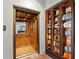 View of wood-paneled elevator interior with ceiling light and adjacent built-in display case filled with vintage radios and clocks at 501 Brightwaters Ne Blvd, St Petersburg, FL 33704