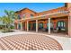 Beautiful Mediterranean-style home with covered patio, herringbone brickwork, and lush landscaping at 501 Brightwaters Ne Blvd, St Petersburg, FL 33704