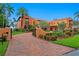 Impressive Mediterranean-style home with a brick driveway, lush landscaping, and private gate at 501 Brightwaters Ne Blvd, St Petersburg, FL 33704
