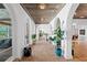 Spacious foyer features arched doorways, brick flooring, a beamed ceiling, and views through the home's interior at 501 Brightwaters Ne Blvd, St Petersburg, FL 33704