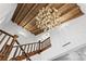 Staircase and foyer featuring a wooden-beam ceiling, chandelier, and bright white walls at 501 Brightwaters Ne Blvd, St Petersburg, FL 33704
