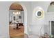 Arched doorway to foyer with decorative lighting, terracotta tile floor, and seating area at 501 Brightwaters Ne Blvd, St Petersburg, FL 33704
