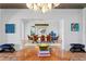 Foyer with terracotta tile floor, decorative chandelier, seating, and view to dining room at 501 Brightwaters Ne Blvd, St Petersburg, FL 33704