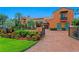 Spanish style home with an orange facade, terra cotta tile roof, and a brick driveway at 501 Brightwaters Ne Blvd, St Petersburg, FL 33704