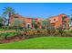 Stunning orange Spanish-style home with a lush landscaped front yard, garden and brick driveway at 501 Brightwaters Ne Blvd, St Petersburg, FL 33704