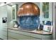 Gourmet kitchen with custom cabinets, blue backsplash, and chef's range hood at 501 Brightwaters Ne Blvd, St Petersburg, FL 33704