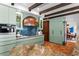 Bright kitchen with custom cabinetry, copper hood, and terracotta floors open to the dining room at 501 Brightwaters Ne Blvd, St Petersburg, FL 33704