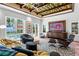 Stylish living room with ocean view, comfortable seating, patterned rug, and unique ceiling design at 501 Brightwaters Ne Blvd, St Petersburg, FL 33704