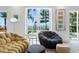 Bright living room showcasing coastal views through French doors and comfortable seating, with neutral decor at 501 Brightwaters Ne Blvd, St Petersburg, FL 33704