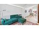 Cozy living room featuring a green sofa and views into the art studio at 501 Brightwaters Ne Blvd, St Petersburg, FL 33704