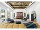 Open living room with unique decor, tile floors, plenty of natural light, and a striking geometric ceiling at 501 Brightwaters Ne Blvd, St Petersburg, FL 33704