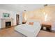 Light-filled main bedroom features a cozy fireplace and muralled accent wall at 501 Brightwaters Ne Blvd, St Petersburg, FL 33704