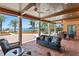 Covered patio featuring comfortable seating, ceiling fans, and stunning water views at 501 Brightwaters Ne Blvd, St Petersburg, FL 33704