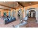 Covered patio features tiled floors, ceiling fans, and rattan furniture at 501 Brightwaters Ne Blvd, St Petersburg, FL 33704