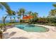 Backyard pool features stone deck, landscaping, and two colorful umbrellas at 501 Brightwaters Ne Blvd, St Petersburg, FL 33704