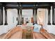 Sitting room featuring wood floors, dark pillars, and sofas at 501 Brightwaters Ne Blvd, St Petersburg, FL 33704