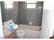 A cozy bathroom with a tub, tiled walls, and a small window at 5581 Greyston St, Palm Harbor, FL 34685