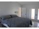Bedroom with white walls, ceramic tile flooring, and a large bed at 5581 Greyston St, Palm Harbor, FL 34685