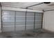 The inside of a residential garage with a large sectional garage door in the closed position at 5581 Greyston St, Palm Harbor, FL 34685