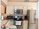 Bright kitchen featuring stainless steel appliances and white cabinets at 5581 Greyston St, Palm Harbor, FL 34685