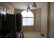 Kitchen with white cabinets, stainless appliances, and tiled flooring at 5581 Greyston St, Palm Harbor, FL 34685