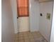 A laundry room with a back door and a window, providing an exit and natural light at 5581 Greyston St, Palm Harbor, FL 34685