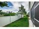 Green backyard with a white fence and view of the water at 575 53Rd N Ave, St Petersburg, FL 33703