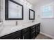 Primary bathroom with a double sink vanity, framed mirrors, and a window with natural light at 575 53Rd N Ave, St Petersburg, FL 33703