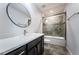 Bathroom featuring a vanity with double sinks, quartz countertop, and framed mirrors at 575 53Rd N Ave, St Petersburg, FL 33703