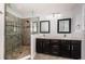 Bathroom with a double sink vanity, tile floors, and a frameless glass shower with custom tile work at 575 53Rd N Ave, St Petersburg, FL 33703