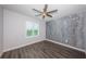 Bedroom with hardwood floors, a ceiling fan, a window, and a accent wall at 575 53Rd N Ave, St Petersburg, FL 33703