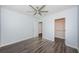 Bedroom with ceiling fan, wood floors, and a walk-in closet for ample storage at 575 53Rd N Ave, St Petersburg, FL 33703