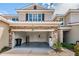 Two-car garage with stone accents and a landscaped front yard enhances curb appeal at 575 53Rd N Ave, St Petersburg, FL 33703