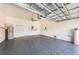 Spacious garage with epoxy flooring, water heater, and utility sink at 575 53Rd N Ave, St Petersburg, FL 33703