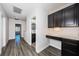 Hallway with dark wood floors, built-in desk and cabinets, and a view of the bathroom at 575 53Rd N Ave, St Petersburg, FL 33703