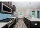 Modern kitchen featuring stainless steel appliances, dark cabinets, white countertops and attractive pendant lighting at 575 53Rd N Ave, St Petersburg, FL 33703