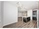 Open concept kitchen with modern island, stainless appliances, pendant lighting and wood floors at 575 53Rd N Ave, St Petersburg, FL 33703