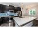 Bright kitchen features stainless steel appliances, dark cabinets, white countertops and pendant lighting at 575 53Rd N Ave, St Petersburg, FL 33703