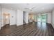 Spacious living room boasts modern gray flooring, sleek ceiling fans and an adjacent kitchen with natural light at 575 53Rd N Ave, St Petersburg, FL 33703