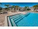 The pool has easy access steps with stainless steel handrails and a shaded pergola with lounge chairs nearby at 575 53Rd N Ave, St Petersburg, FL 33703