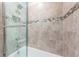 Shower in bathroom with subway tile and decorative tile border at 575 53Rd N Ave, St Petersburg, FL 33703