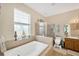 Bathroom features a large tub, tiled shower, and vanity with ample counter space at 5806 Tulip Flower Dr, Riverview, FL 33578