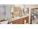 Bathroom featuring double sinks, framed mirrors, and a separate shower and toilet area at 5806 Tulip Flower Dr, Riverview, FL 33578