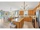 Open-concept kitchen features an island, stainless appliances, and seamless flow into the dining and living areas at 5806 Tulip Flower Dr, Riverview, FL 33578