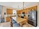 Well-lit kitchen with granite countertops, stainless steel appliances, and a center island with seating at 5806 Tulip Flower Dr, Riverview, FL 33578