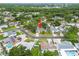 An aerial view shows the home's location on a tree-lined street in a residential neighborhood with nearby lake access at 6204 Walsh Ln, Tampa, FL 33625